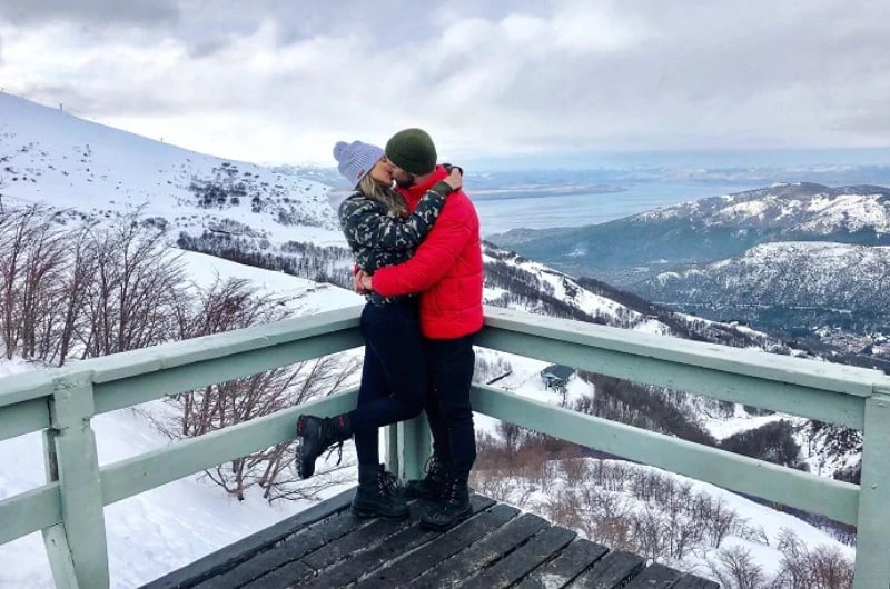 Casal em mirante nevado do Cerro Catedral, em Bariloche
