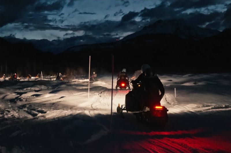 Moto de neve com o farol aceso à noite em Ushuaia
