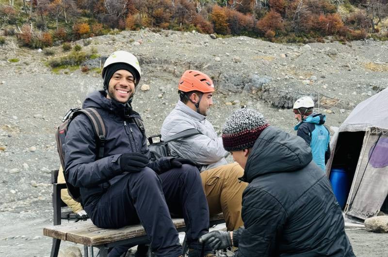 Viajantes com capacete colocando grampones antes do Mini Trekking
